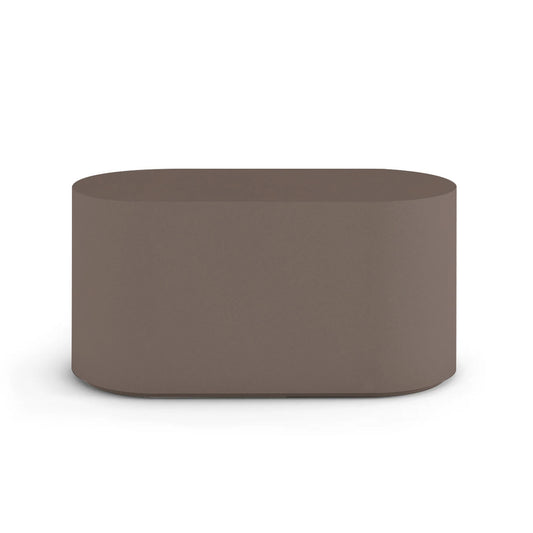 Side profile of the Capitola Oval Concrete Table, highlighting the seamless GFRC construction and soft oval shape, shown in the Riverbed Earth finish.