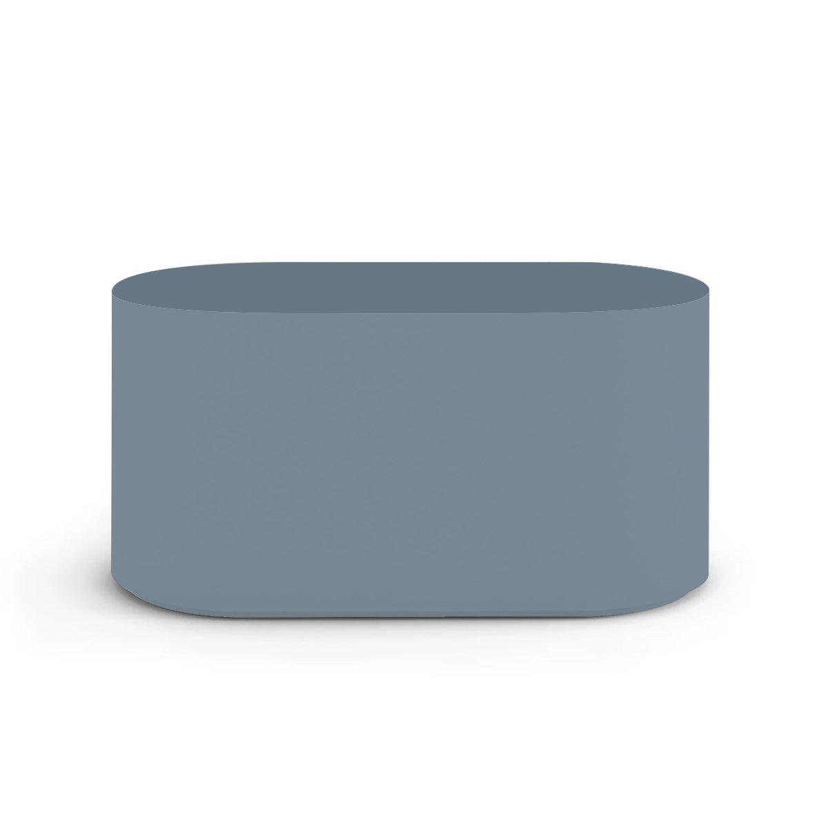 Side profile of the Capitola Oval Concrete Table, highlighting the seamless GFRC construction and soft oval shape, shown in the Seafoam Slate finish.