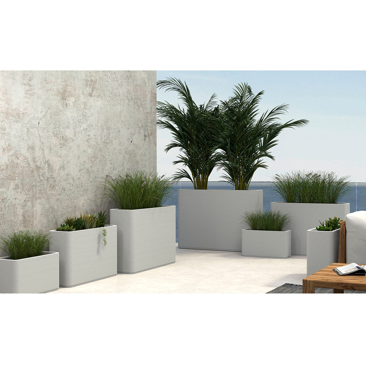 A group of Avila Rectangular Planters in Glacial Mist 3D-printed concrete with ribbed texture, modern lightweight GFRC design for indoor or outdoor use