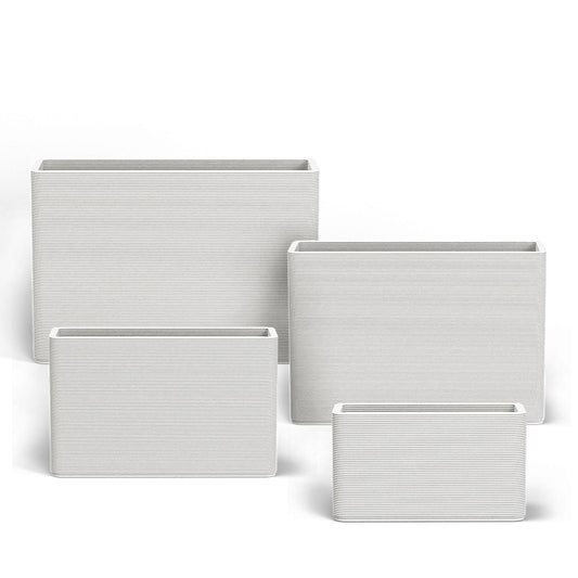 Set of Avila rectangular concrete planters in varying sizes featuring a stacked-patterned GFRC finish for indoor or outdoor use in the Glacial Mist finish.